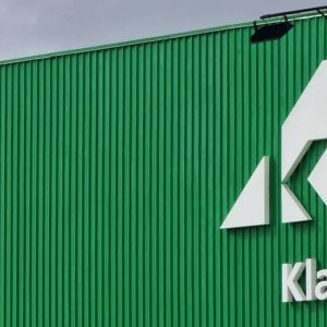 Foto de um pavilhão verde da Klabin (KLBN11) com o logo da empresa, conhecida por pagar dividendos