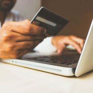 Pessoa comprando produtos pela internet com cartão de crédito